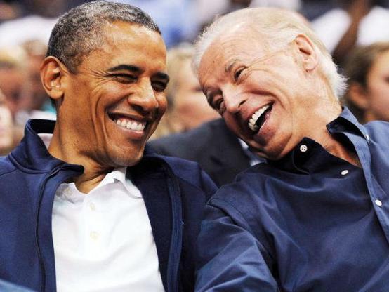 Barack Obama and Joe Biden laughing.