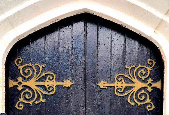 A set of large, ornate hinges on an 1860s Glasgow Church.