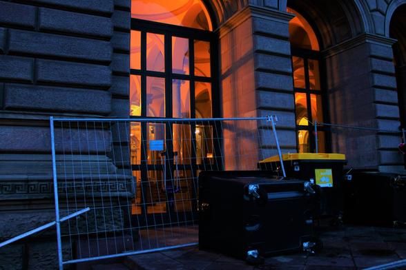 Poubelles et barrières devant l'entrée principale du palais universitaire