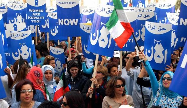 Arabic women holding placards calling for the right to vote.