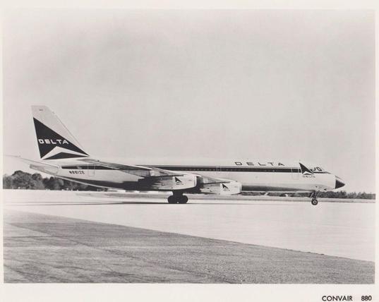 black and white photo of the plane sitting on the tarmac somewhere