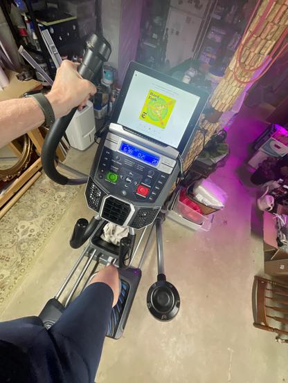 Working out on elliptical listening to podcasts on iPad mounted to my exercise machine