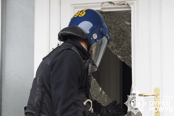 Police officer raids property in Llanelli