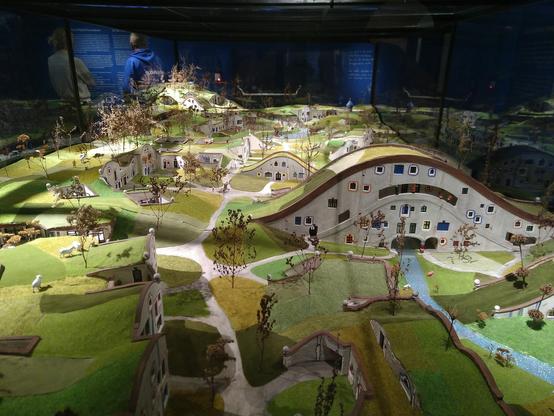 Titel: In the Meadow Hills. 
In order to provide an alternative to overdevelopment. Hundertwasser planned Meadow Hills in the 1980s, a housing development in northern Vienna. This community of energy-efficient houses nested into the landscape was designed to grow with the families that inhabit it. All buildings were to have green roofs to be used as meadows, forests, and vegetable gardens. The project was never realised in Vienna due to resistance from a local citizens' initiative that feared distrurbances caused by tourism to Hundertwasser's architecture marvel. 

As a different project, Hundertwasser's Rolling Hills concept was eventually realised in the 1990s, but not in the form of an urban housing development. Instead, it was further developed as a leisure complex for the Rogner Bad Blumau thermal spa in eastern Styria. There, Hundertwasser was able to construct buildings nested into a meadow landscape, the likes of which he had designed in the 1970s as prototypes of his visions of a life lived in harmony with nature, such as the Augenschlitzhaus (eye-slit house) and the Waldhofhaus (forest-courtyard house). 

1-7 (see post)
8. granting of window rights
9. more quality of life for the neighbours, not just for the residents
10. an Austrian way out of the cul-de-sac of city planning which will be a precedent worldwide. 

Excerpt from Hundertwasser's mifesto "In the Meadow Hills", 1989/1996