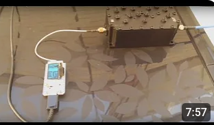a Heltec rnode connected to a cavity filter which is a large box that looks like a lego block