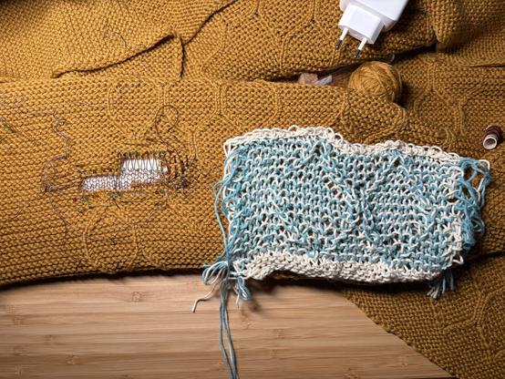 loosely knitted swatch of two hexagons on top of a hole prepared for swiss darning