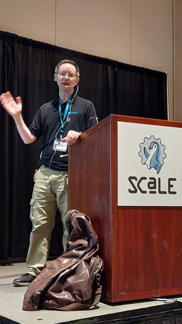 Shaun Thomas on stage at SCaLE 22x
