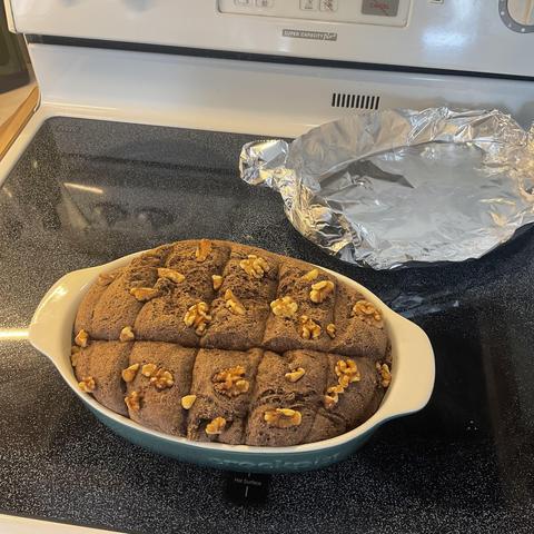 A loaf of freshly baked cacao bread in the baking dish.