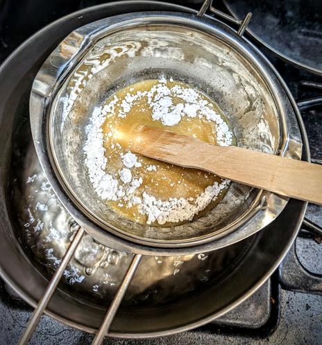 Stirring the powdered gypsum into the hide glue and molten rosin, linseed oil mixture in a double boiler. Rough temperature of 140⁰F