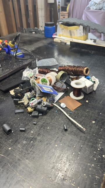 A pile of copper and aluminium wire coils, chokes, batteries, and other random shit. On my bench. Nearly done!