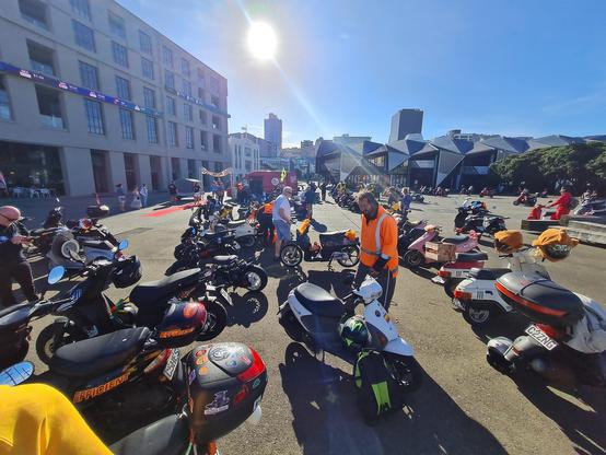 Photo of Baxter's scooter amongst other scooters across the Napier Scooter Challenge finish line in Wellington.