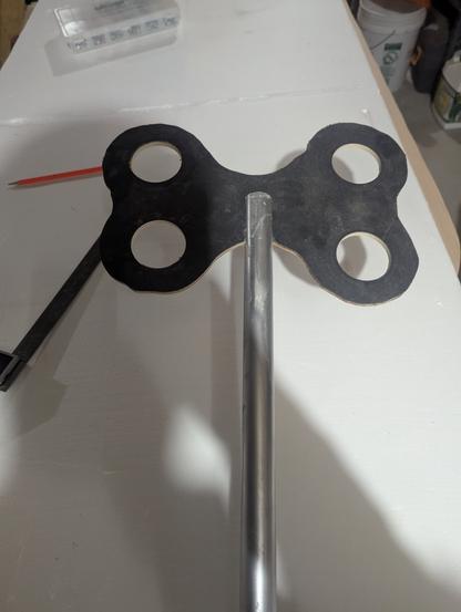Prop twist key / butterfly knob 
Black plywood cut into a butterfly like shape, with holes, slotted into a PVC pipe.
