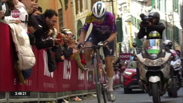 cyclist on a strip climb followed by camera motorbikes