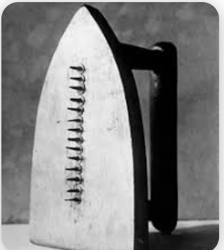 Man Ray's "The Gift." Sculpture of iron with nails down the middle.