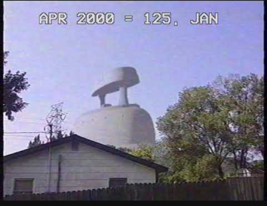 giant iron in the distance seen from a neighbourhood with trees and a house in view in the foreground