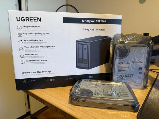 UGreen 2bay NAS with 2 28TB hard disks beside it