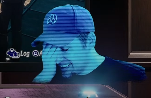 Zero in Junpei's baseball cap face palming on stream.  Blue holograph coloration with faintly visible scanlines running through it, projected from a small blue light puck below.