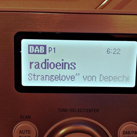 This picture shows a digital radio displaying the name "Radios" along with other information, but the resolution does not allow for the full text to be read. The context suggests that it is a screenshot from a radio station's interface. The overall mood or intention of the image is informative and functional, typically related to music and media content on a radio platform.