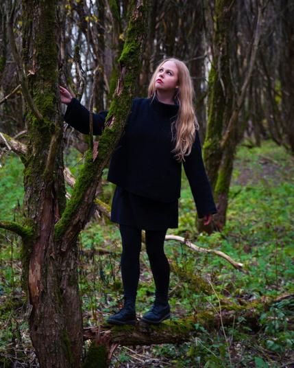 A finnish woman with bonde hair in an autumn forest
