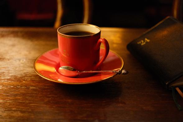 Red coffee mug and notebook.