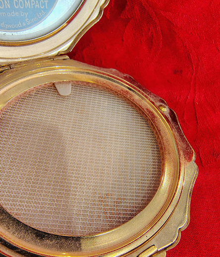 Compact with powder applicator removed