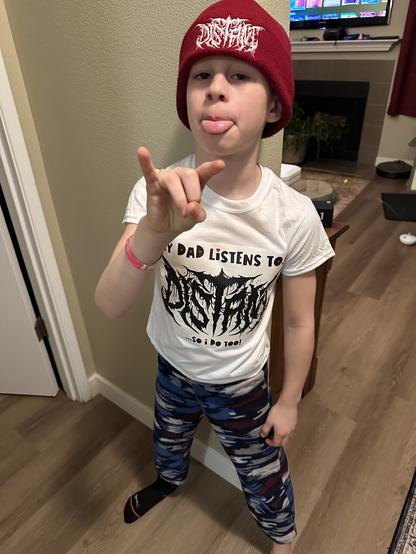 8yo boy wearing a Distant beanie and a t-shirt that reads: 
my dad listens to.. 
Distant (band logo)
.. so I do too!

8yo is throwing the metal horns.