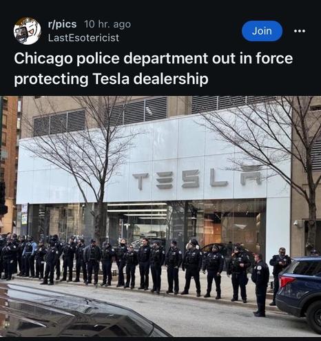 Post from r/picks it says “Chicago police department out and force protecting Tesla dealership”
The picture is taken from the street across from a Tesla dealership and there are a line of uniform police officers in front of the dealership standing on the curb between the street and the sidewalk facing the street, there are at least 30 of them.  

I don’t think anything is happening there, I don’t see any protesters in the picture and I haven’t seen any stories online about some massive looting in Chicago or anything that would warrant this type of response.