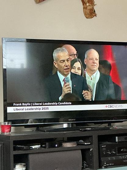 A man speaks at a microphone.
