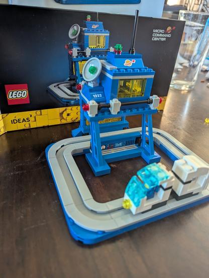 Lego Micro Command center - set 40786 - blue space command module with a grey monorail track and a tiny spaceman in a tiny monorail car.