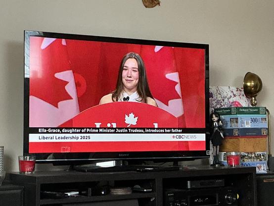 A young woman speaks surrounded by red.