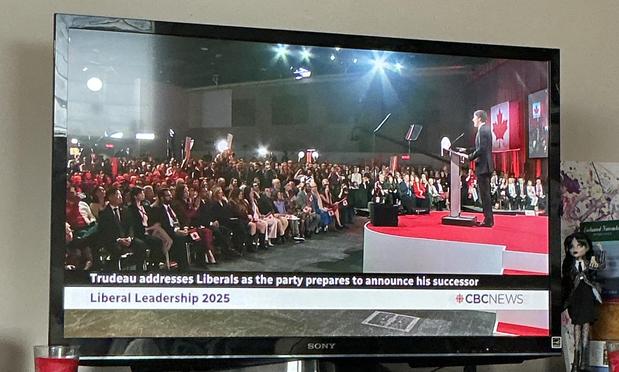 A side shot shows trudeau standing on stage looking out to the crowd.