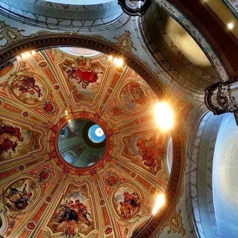 This picture shows a ceiling with intricate designs and paintings, possibly from an old building or church. The main topic of this image is to showcase the beauty and craftsmanship of the ceiling's architecture and artistry.

The mood or intention behind this image could be to highlight the historical significance, cultural importance, or artistic value of the ceiling, inviting viewers to appreciate its intricate details and aesthetic appeal.

There are no visible or readable texts in the image.