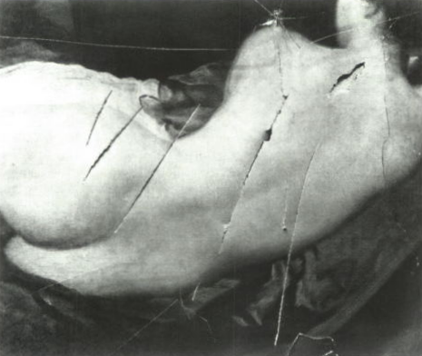 black and white photograph of the damage done to the painting. The painting is of a nude woman reclining with her back to us.