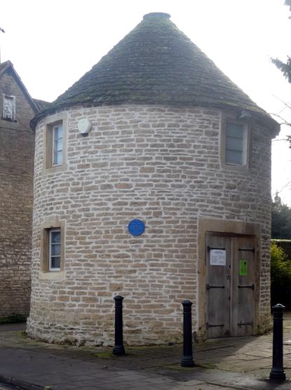 Cylindrical building, with a Blue Plaque.
