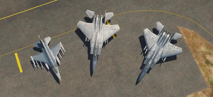 Screenshot from DCS, the picture is from above. Three fighter aircraft, left to right F-16, F-15E air to ground Strike Eagle and a F-15C air superiority fighter. They are fanned out like on the circumference of a circle on an apron next to each other all pointing towards the middle.