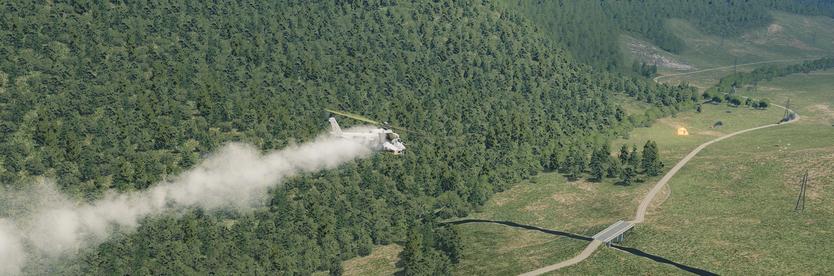 Screenshot from DCS, a smoking Mi-24P hind flying from left to right attacking some ground targets on the right. An explosion can be seen from a weapon impact on a vehicle and a few other vehicles on fire. The backdrop is a forested valley and a road running through it with a bridge crossing a river.