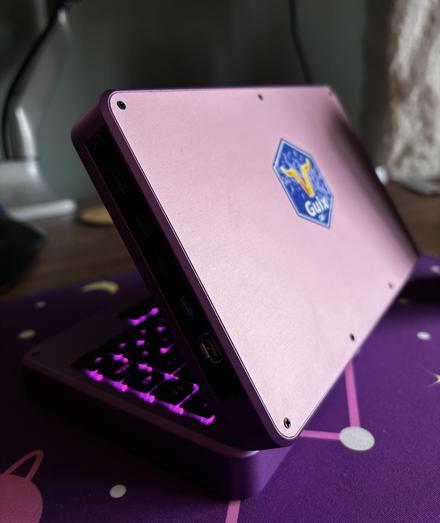 a mnt pocket reform with a purple top plate which was cnc milled and a Guix sticker in the centre of it