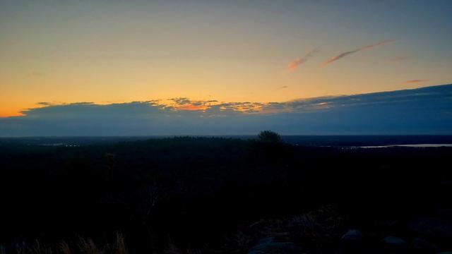 Clouds cover the horizon of a dawn sky.
