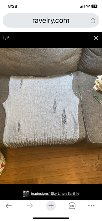 Finished back panel of Earthly, a distressed drop stitch sweater in Patons Linen in Sky color way, a gray light blue