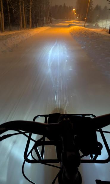 -8°C and snowall, 25km/h e-bike through the darkness with good standard of snow clearence of priority cycle paths.

I bike 6km to work and it"s quite enjoyable. Umeå is one of the best biking and winter biking cities in Sweden. Bike is modal share ~30% during September.