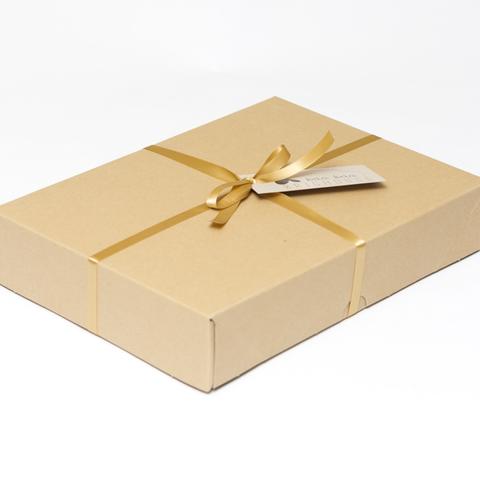 Picture shows a closed A4 box tied with gold ribbon.