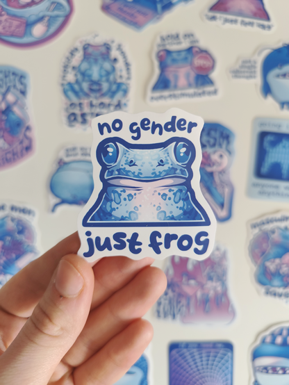 hand holding up a sticker of a blue frog titled "no gender, just frog"