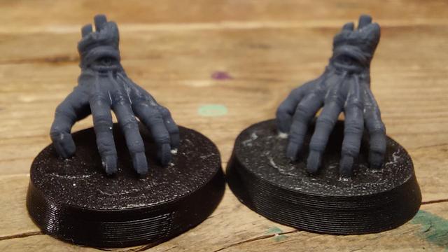 Two disembodied giant hands with eyes in the wrists walking on long fingernails. My colleague printed these for me to use in a Golem Secret League Blood Bowl team