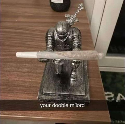 knight statuette bending at the knee and holding a prewrapped on outstretched arms with the text 'your doobie m'lord'