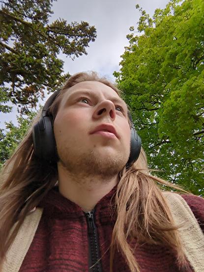 A man is looking into the unknown.

Trees adorn the background.