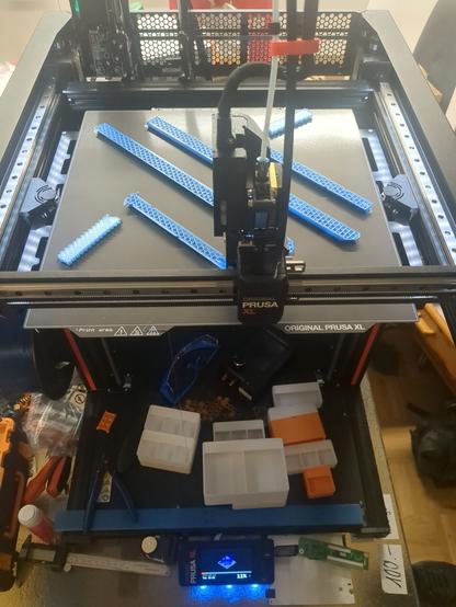 A Prusa XL printer printing blue PCTG.