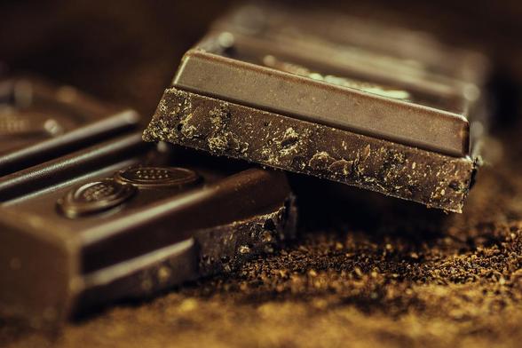 Image shows a bar of chocolate broken in half. It is glossy, dark brown with sort of sparkly crumbs where snapped into two and looks very inviting. Chocolate like this can be produced in a range of different conditions. The researchers investigated how emotional messages influence the willingness to pay for fairly produced chocolate. Thanks to  pixabay/AlexanderStein for the freely available image.