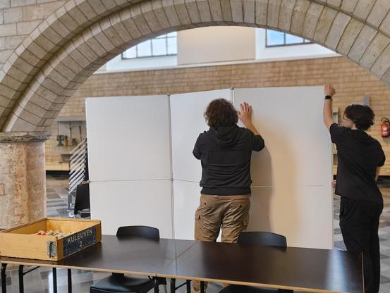 2 people setting up poster boards