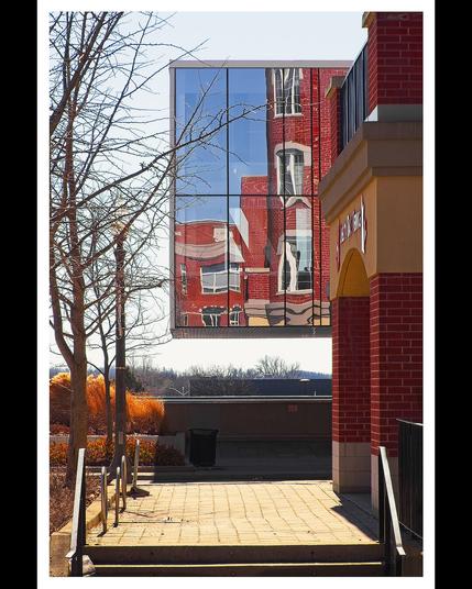 Reflection of a building off a window across the street.  Looks like a portal to another world.