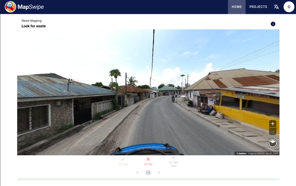 Screenshot of the MapSwipe web app showing a street-view image and asking the user to identify waste